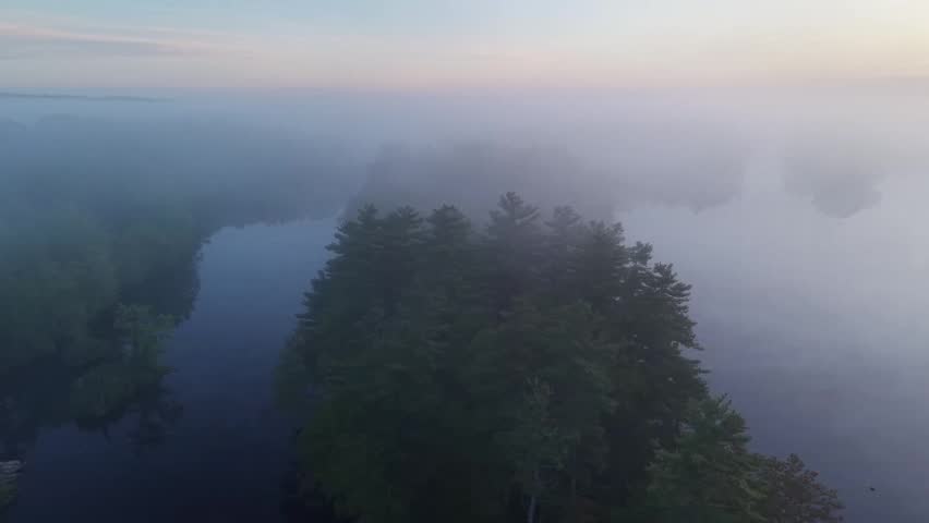 Highlights of dam on the Penobscot River in Old Town on a foggy spring morning  