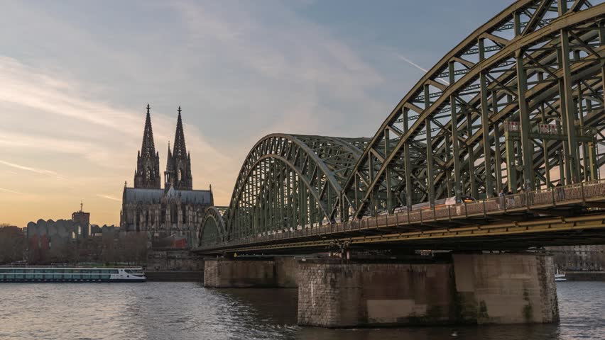 Cologne (Koln) Germany time lapse day to night sunset city skyline at Cologne Cathedral (Cologne Dom) with Rhine River and Hohenzollern Bridge