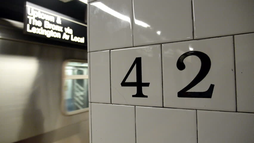A New York City subway approaches the platform.