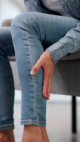 Mature Woman Gently Rubs Leg Easing Muscle Cramp And Swelling Discomfort.