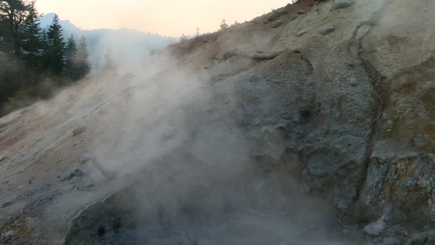 Volcanic gas and steam rising from a boiling mudpot at the Sulphur Works hydrothermal area