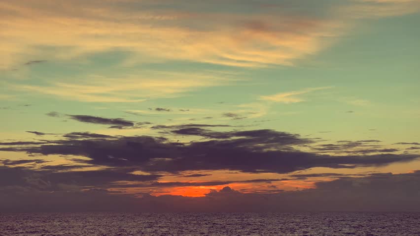 Sunset Over Ocean with Colorful Clouds in the Sky