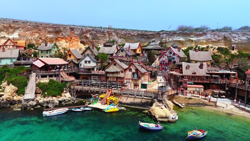 Popeye Village is a colorful theme park in Malta, originally built as the 1980 live-action "Popeye" movie set. It features rustic wooden buildings, boat rides, and family attractions.