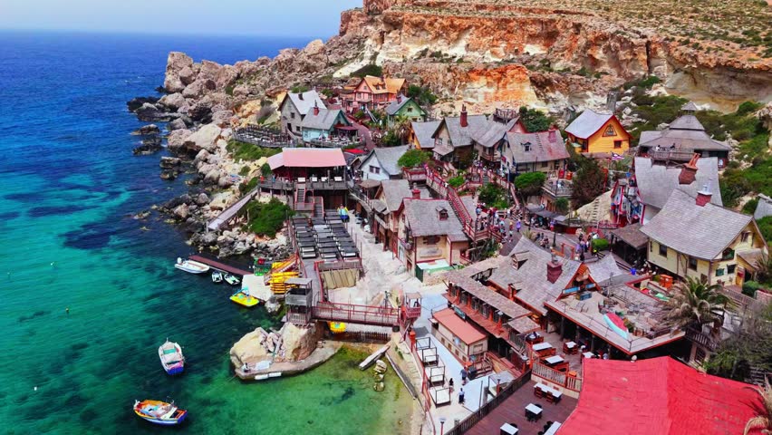 Popeye Village is a colorful theme park in Malta, originally built as the 1980 live-action "Popeye" movie set. It features rustic wooden buildings, boat rides, and family attractions.