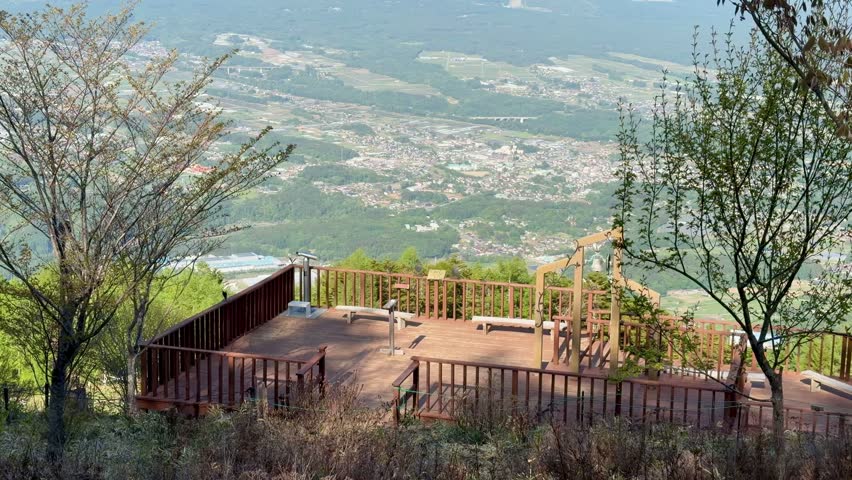 Scenic view of the Yatsugatake Mountains and rural landscape from the Yatsugatake Observatory at Nyukasa Marsh in Nagano Prefecture, Japan.
