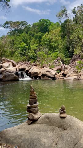 an atmosphere of tranquility and a stone tower on a mountain lake with a waterfall