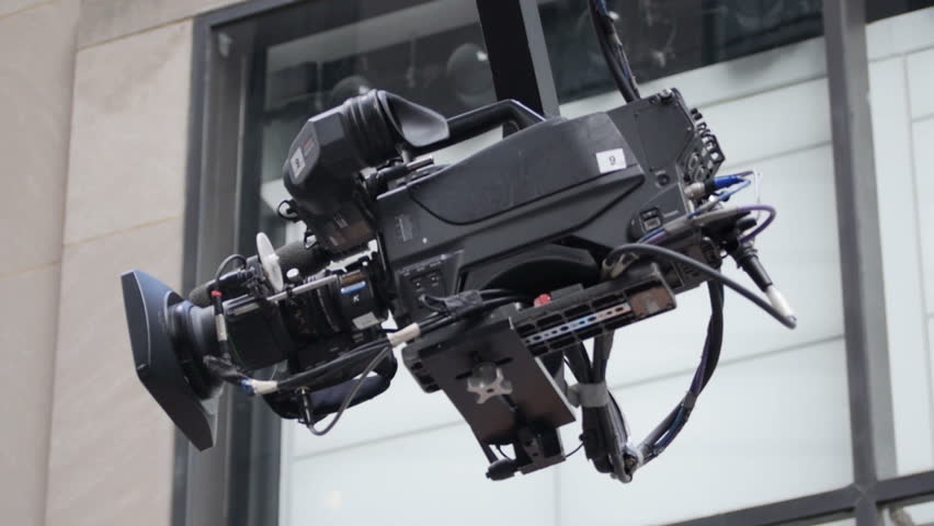A television camera on a crane moves into place.