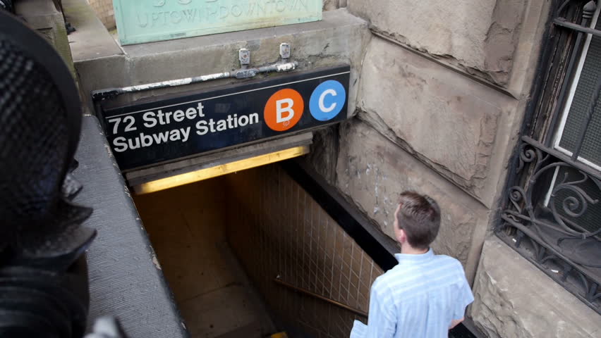A man enters an underground subway station in New York City.