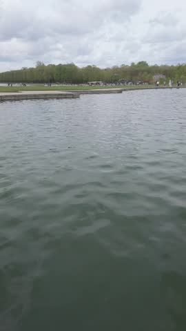 The waters at the Palace of Versailles with visitors at the gardens.