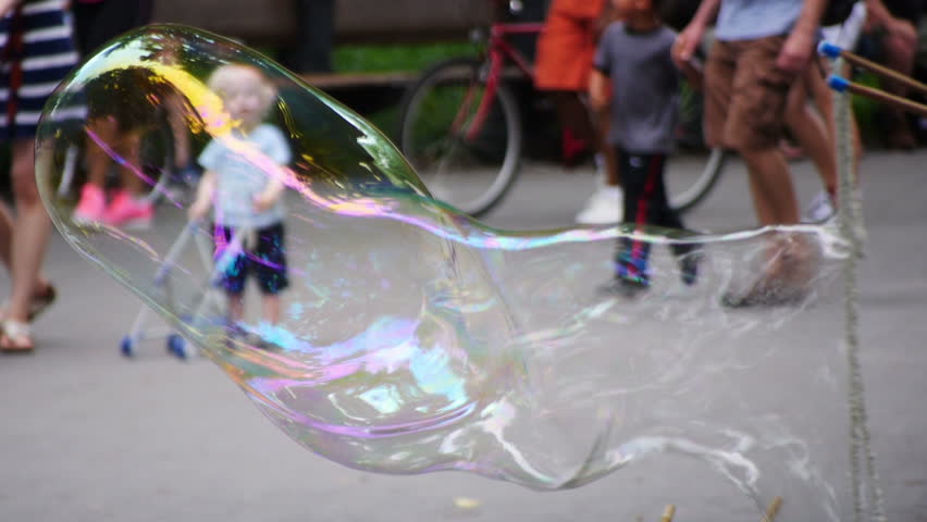 NEW YORK CITY, Circa June, 2013 - A street performer blows large bubbles for the