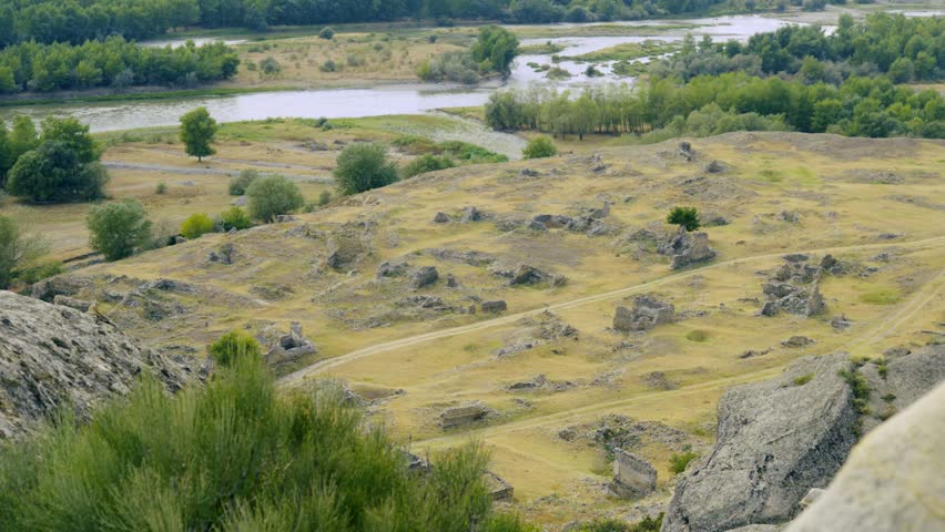 Natural landscape and environmental conservation, panoramic view of rocky hills and river with lush green trees under overcast sky