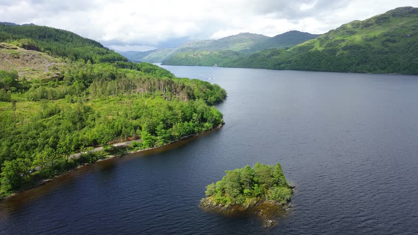 Aerial orbit of Loch Lomond and Tarbet Isle with dramatic lighting and weather. Trossachs National Park - Scotland, UK