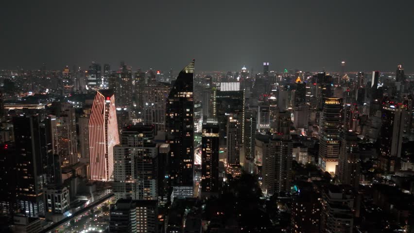 Night view of Bangkok, Sukhumvit Road area, central streets with dense skyscraper development and bright city lights
