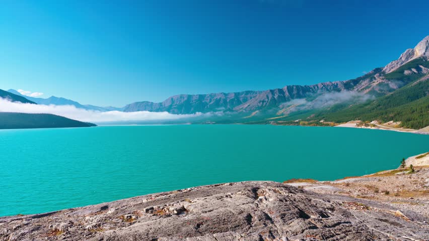 Bright Turquoise Water of Abraham Lake with Canadian Rockies, Alberta
