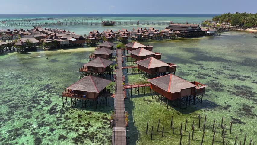 Luxury Resort on a Beautiful Mabul Island. Blue sea with a coral reef and the beach, Aerial. Semporna, Sabah, Malaysia.