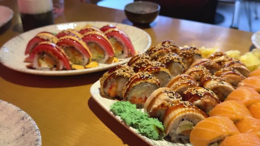 Large sushi platter with salmon tuna Philadelphia rolls and traditional japanese sides