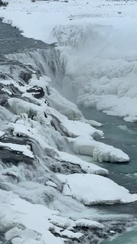 Ice and snow covered waterfall. Gullfoss, Iceland