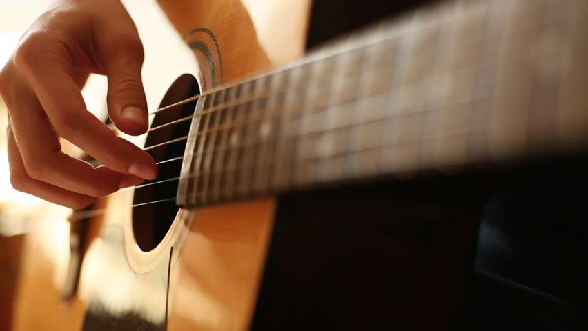 Close-up: fingers touch the strings on the guitar (HD)