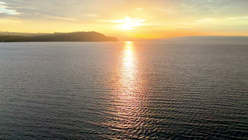 Cinematic aerial view of sunset at Lake Toba