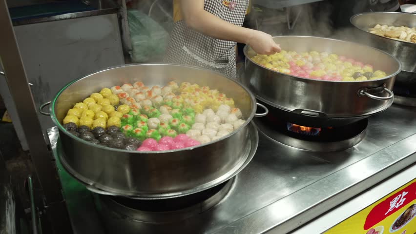 Colorful Tang Yuan Fish Balls Cooking in Large Steaming pot at Chinese Street Food Stall