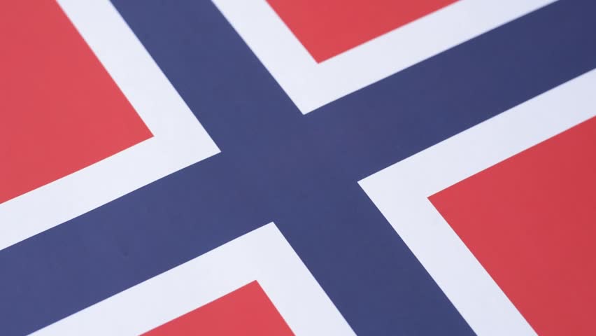 Norwegian national flag in red, blue and white color as a symbol of independence. Flag of Norway