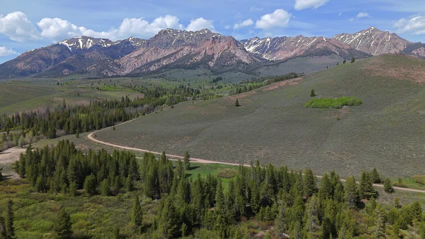 Aerial crane shot of Boulder Mountains in the Sawtooth National Recreation Area, Idaho on a sunny day in spring.