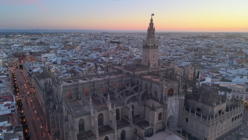 Aerial glimpse of Seville at sunset. Golden hour illuminates historic Seville city and architecture