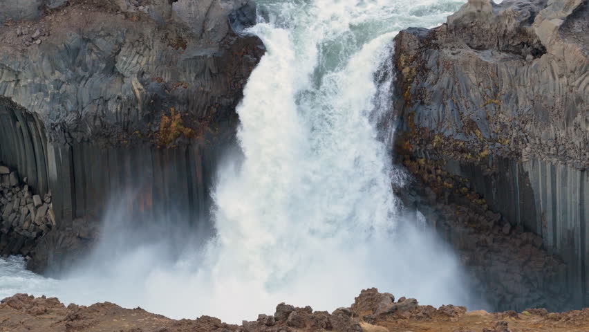 Turquoise waterfall Aldeyjarfoss dropping through a rugged canyon. Iceland