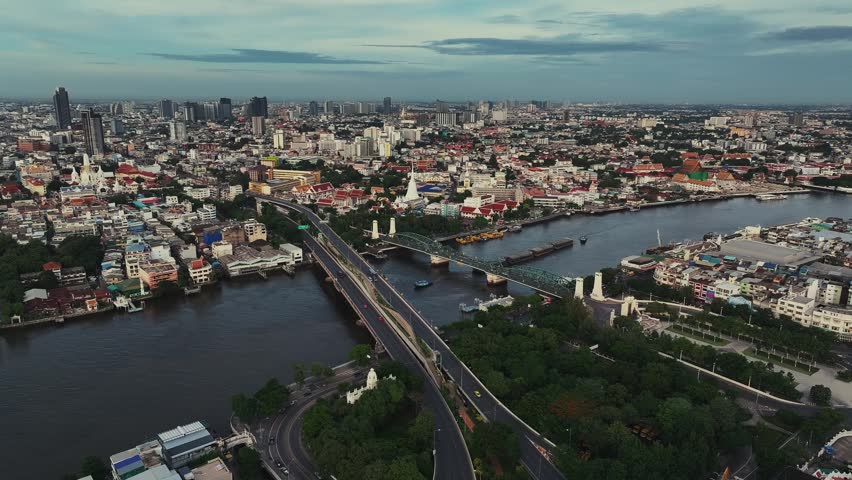 Aerial view of skyline with urban buildings and river in Bangkok, Thailand.