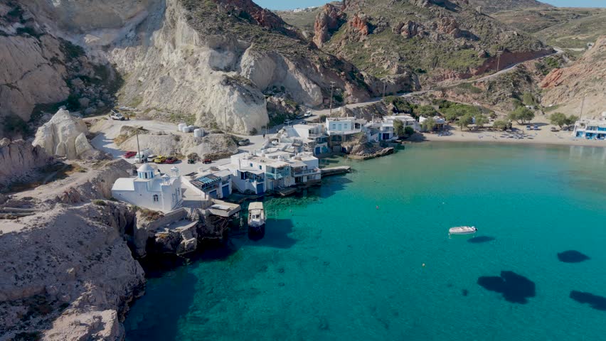 Discover the stunning landscapes of Firopotamos Milos Island in Greece, featuring crystal-clear waters and picturesque whitewashed buildings nestled against striking cliffs