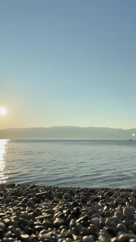 Calm sea sunset with rocky shore and swimmer croatia krk