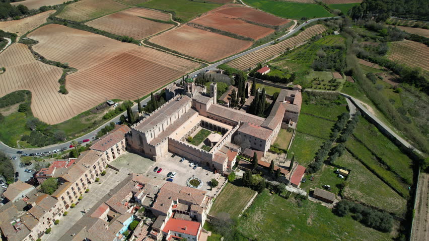 Panoramic aerial shot of Santa Maria de Poblet Monastery on sunny spring day. Tarragona Province, Spain.