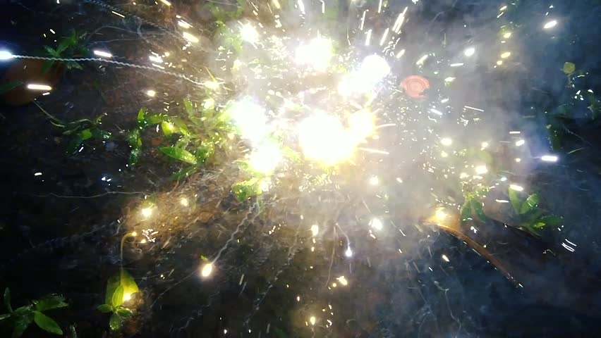 Ground Firework Exploding with Sparks and Smoke in Dark Night - Festive Celebration