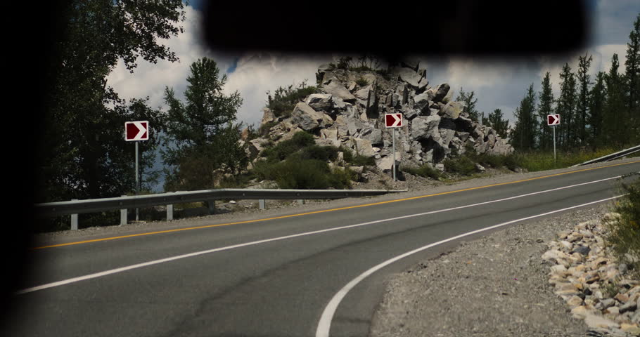 Mountain road curve with guardrail in forest landscape