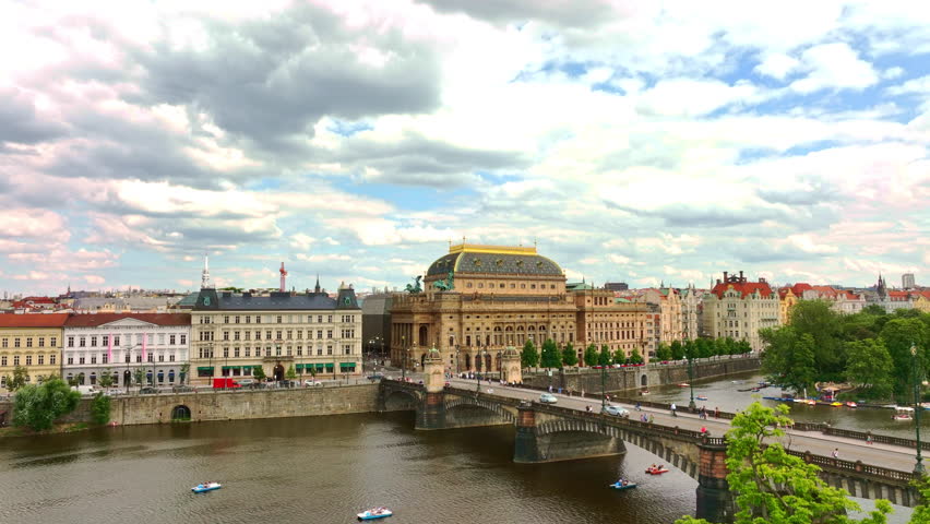 Theatre in Prague city. Opera heritage across water. Theatre historic Prague city center. Theatre stands iconic in Prague near Vltava River. Praha city theatre. Prague opera aerial view.