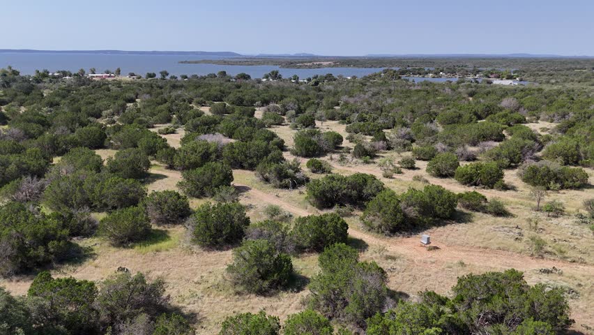 Low flying drone over land in the Texas hill country near Lake Buchanan