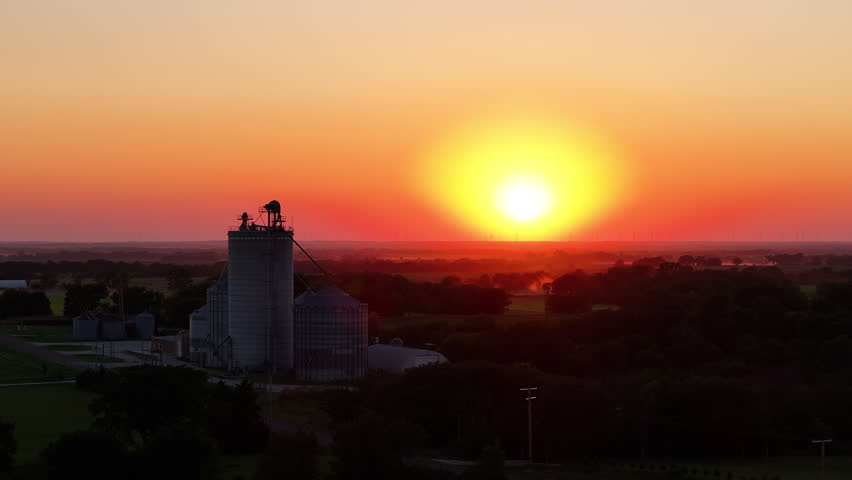 Sunset in Kansas fly by grain silo elevator farm golden hour
