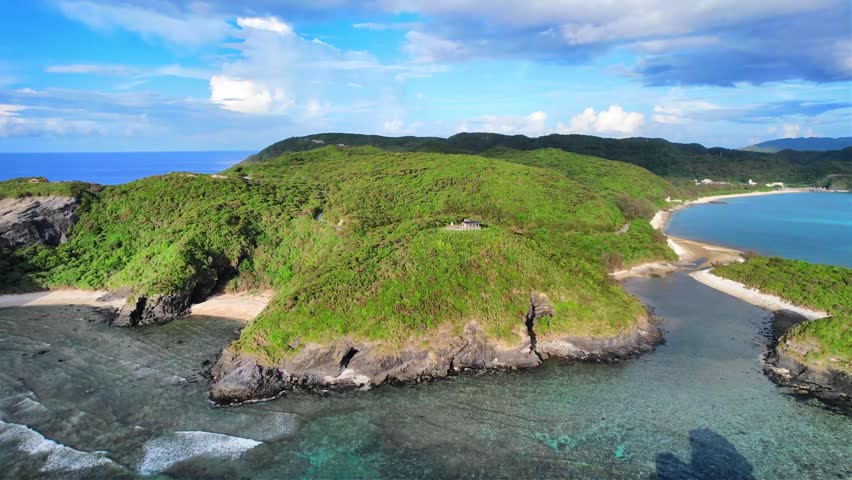 Aerial view of Kaminohama Coast and tropical shoreline in Okinawa, Japan
Drone aerial footage captured near Kaminohama Coast in Okinawa, Japan. Crystal clear turquoise waters, tropical islands, dramatic cloud formations, and beautiful coastal scenery viewed from above.