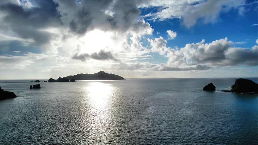 Aerial sunset seascape over Kaminohama Coast and surrounding islands, Okinawa
Drone aerial footage captured near Kaminohama Coast in Okinawa, Japan. Crystal clear turquoise waters, tropical islands, dramatic cloud formations, and beautiful coastal scenery viewed from above.