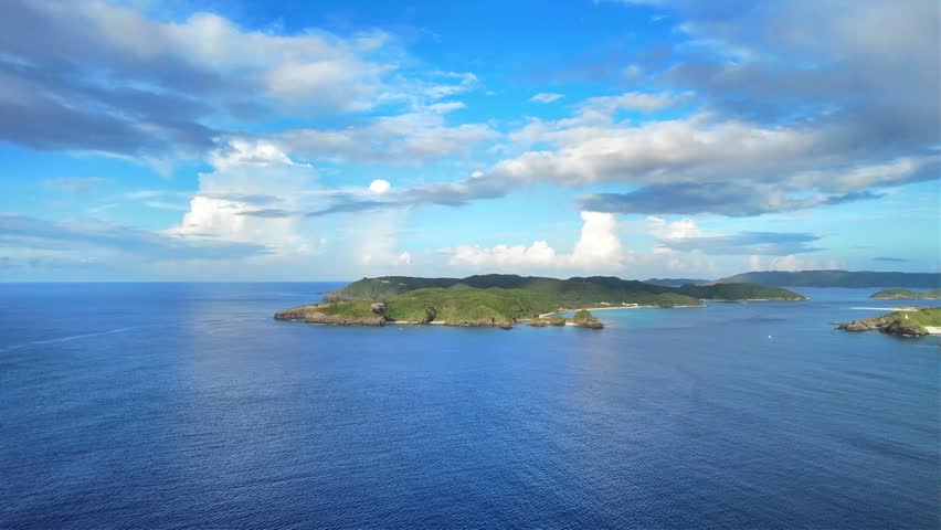 Island landscape surrounded by clear blue ocean in Okinawa, Japan
Drone aerial footage captured near Kaminohama Coast in Okinawa, Japan. Crystal clear turquoise waters, tropical islands, dramatic cloud formations, and beautiful coastal scenery viewed from above.