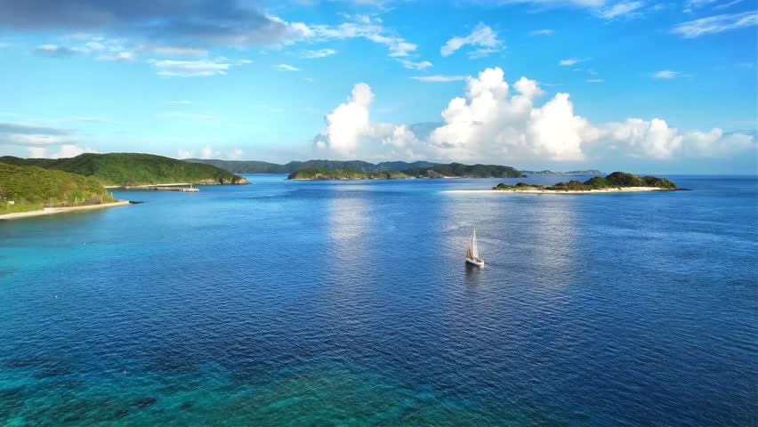 Calm tropical bay and crystal clear water in Okinawa, Japan
Drone aerial footage captured near Kaminohama Coast in Okinawa, Japan. Crystal clear turquoise waters, tropical islands, dramatic cloud formations, and beautiful coastal scenery viewed from above.