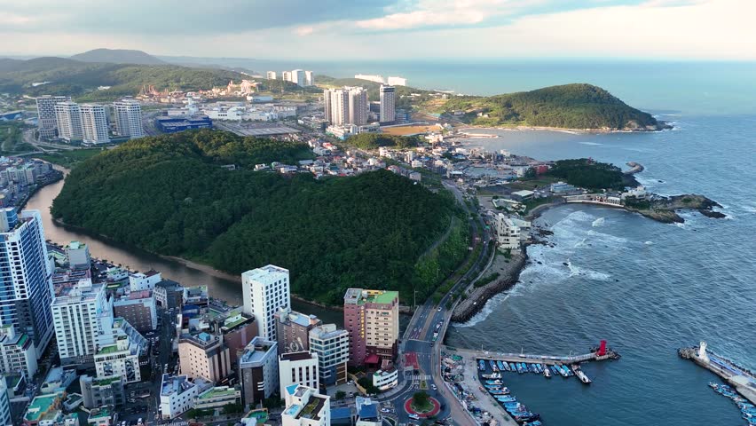 Breathtaking aerial footage capturing the stunning haeundae cityscape, where modern skyscrapers meet the beautiful coast in busan, south korea