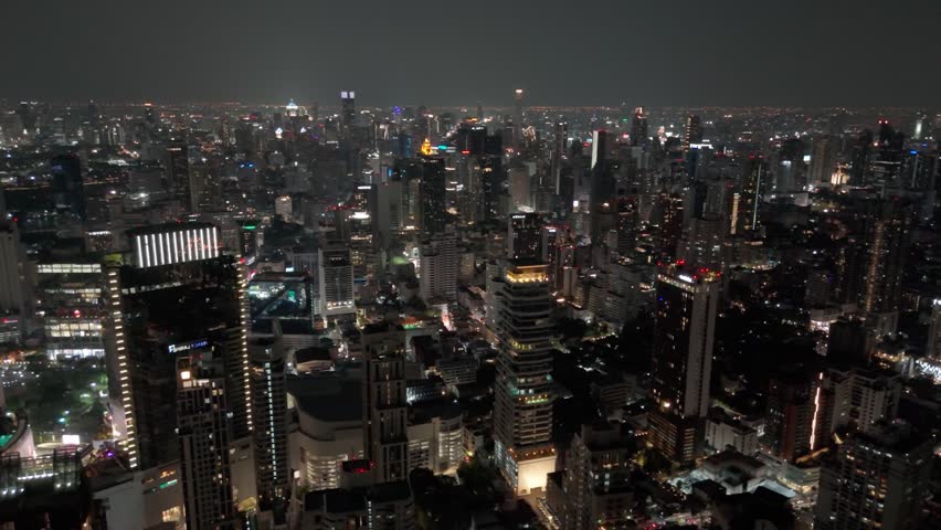 Night view of Bangkok, Sukhumvit Road area, central streets with dense skyscraper development and bright city lights