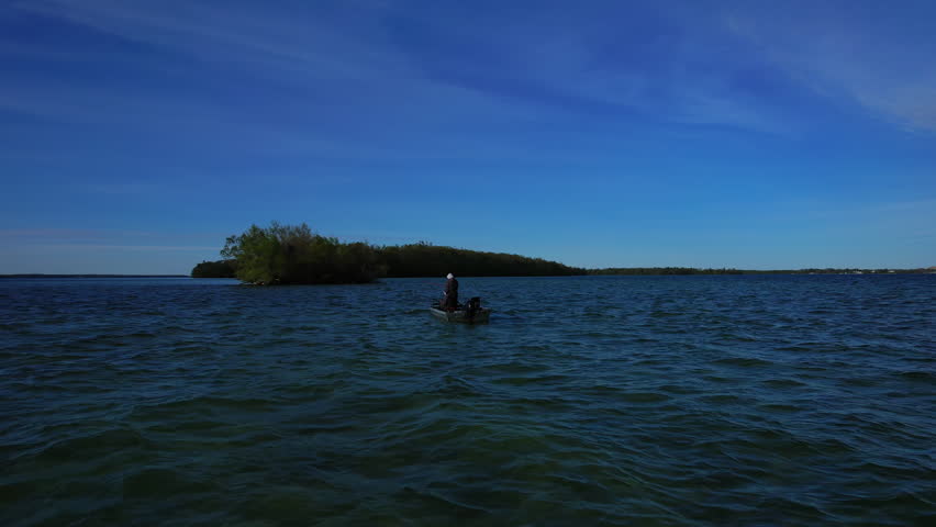 Beautiful lake Couchiching in Orillia Ontario Canada north of Simcoe Lake. Bass season opener. Motor boat with fishermen on water. Aerial view shot. Fishing boat and two anglers enjoying leisure.