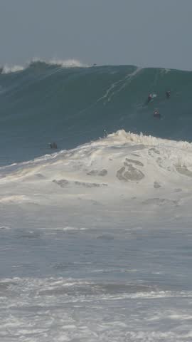 Surfer wiping out on huge wave at the wedge