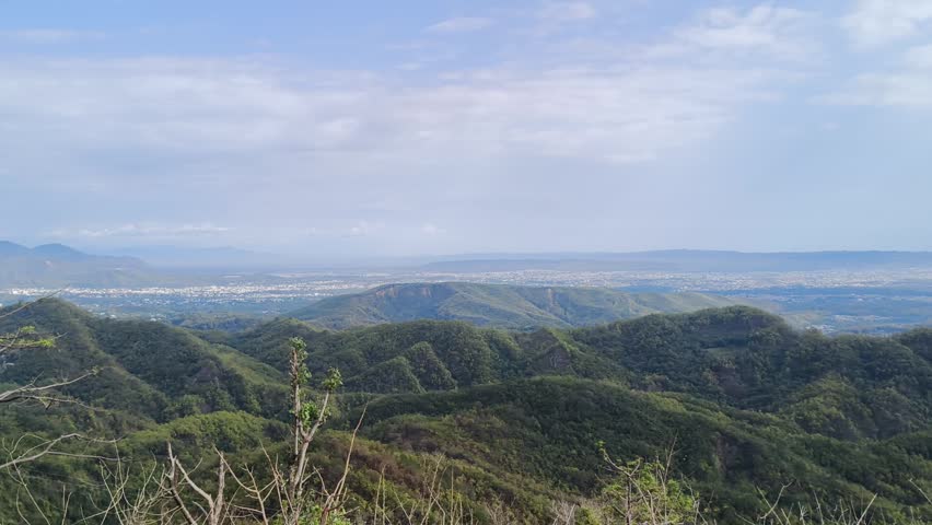Beautiful landscape view of a green valley from the top of a mountain.