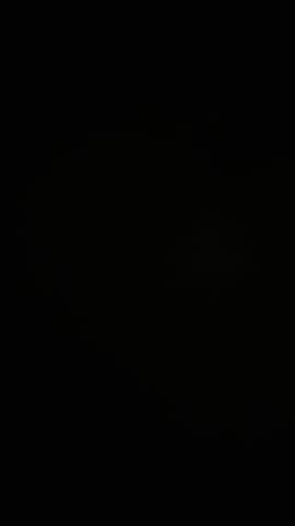 Bright lightning striking in the dark night sky during a storm.