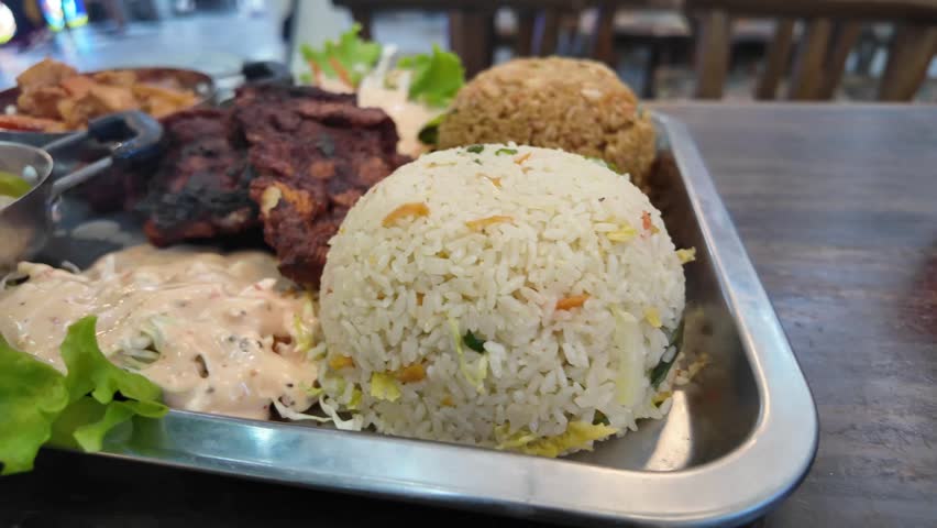 Flavorful lunch platter featuring grilled meat and rice