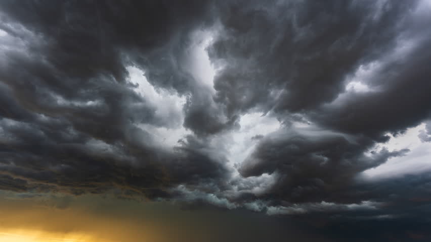 Towering cumulonimbus clouds churn across the sky with dark swirling formations, creating an intense weather scene filled with atmospheric instability, turbulent motion, severe storm energy and dramatic natural power