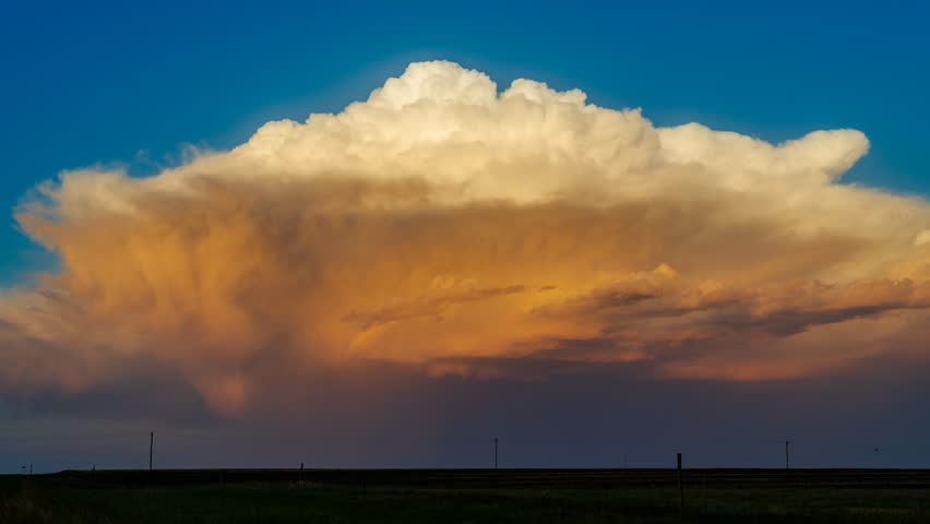 Golden evening light spreads across the sky as storm clouds begin to clear, creating dramatic contrast, rich atmospheric colour, calm post storm ambience and a striking scene after severe weather passes
